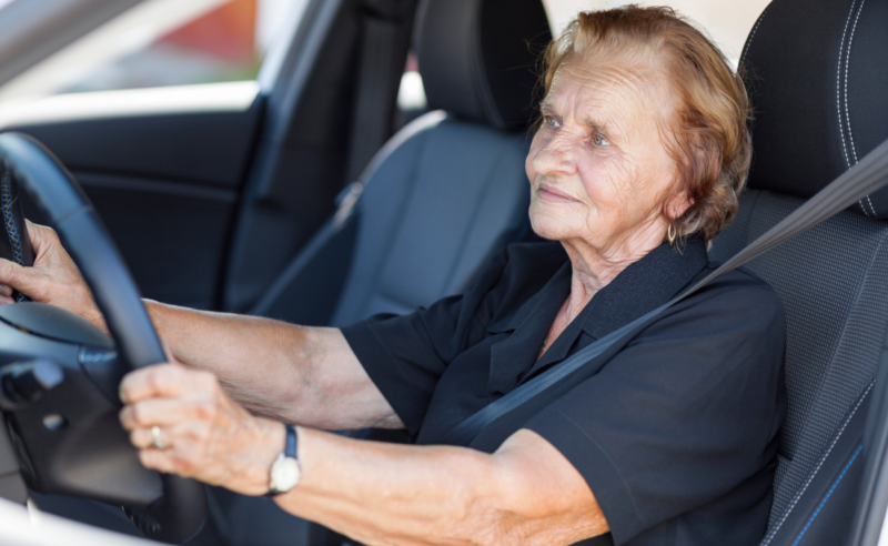 An older woman driving a car.