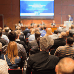 A conference room full of people watching a presentation